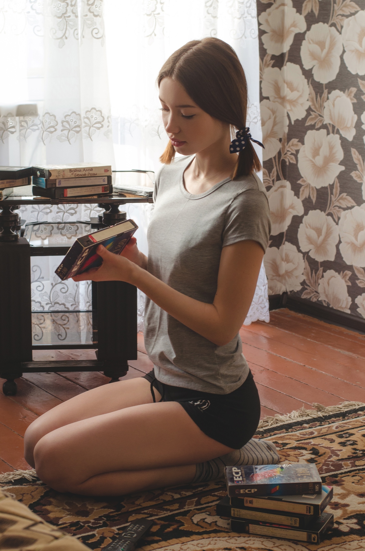 People 1192x1800 Vladislav Opletaev women brunette twintails T-shirt shorts kneeling VHS cassette carpet portrait display