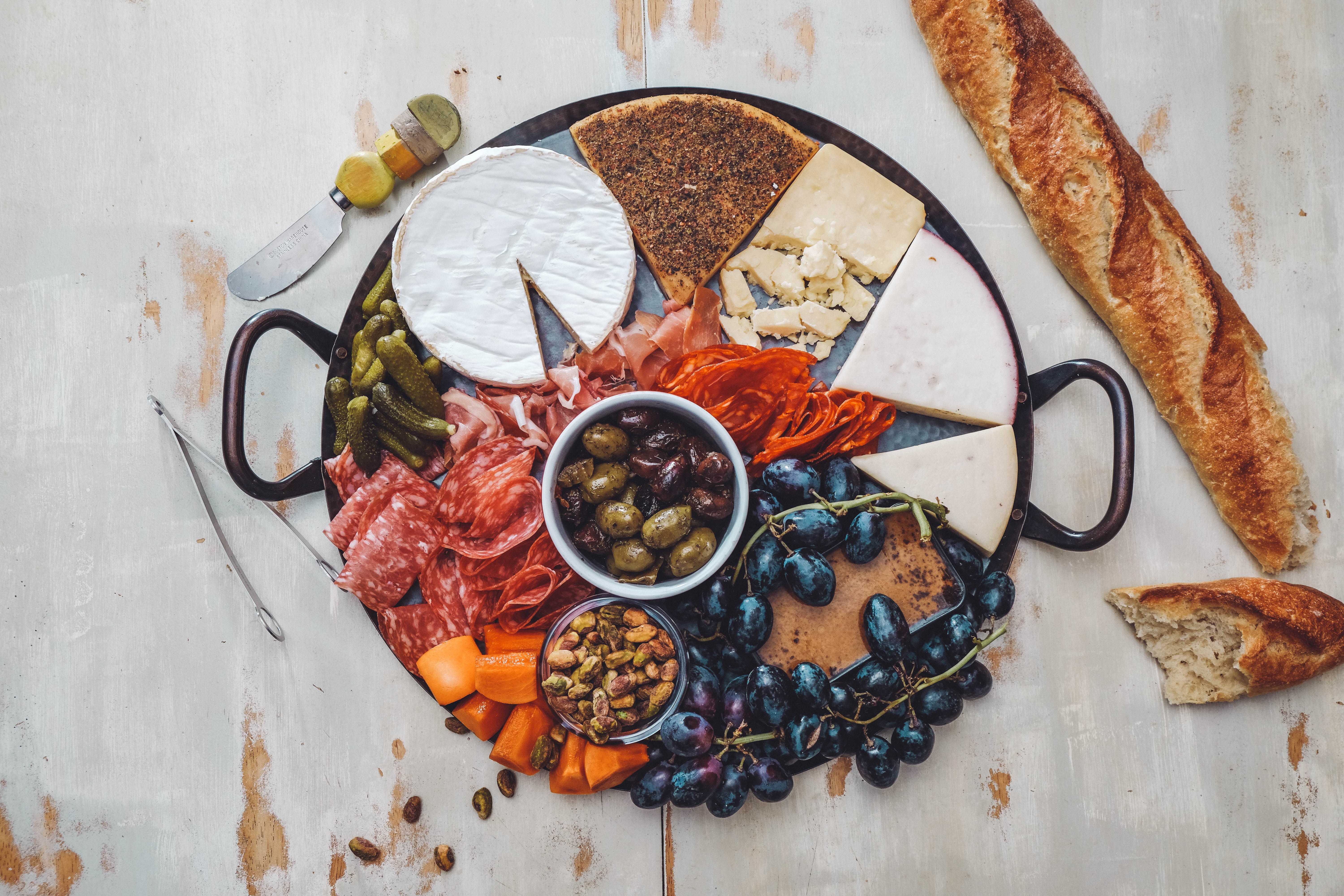 General 6000x4000 food pickles bread fruit cheese olives pistachios grapes brie still life salami knife closeup top view
