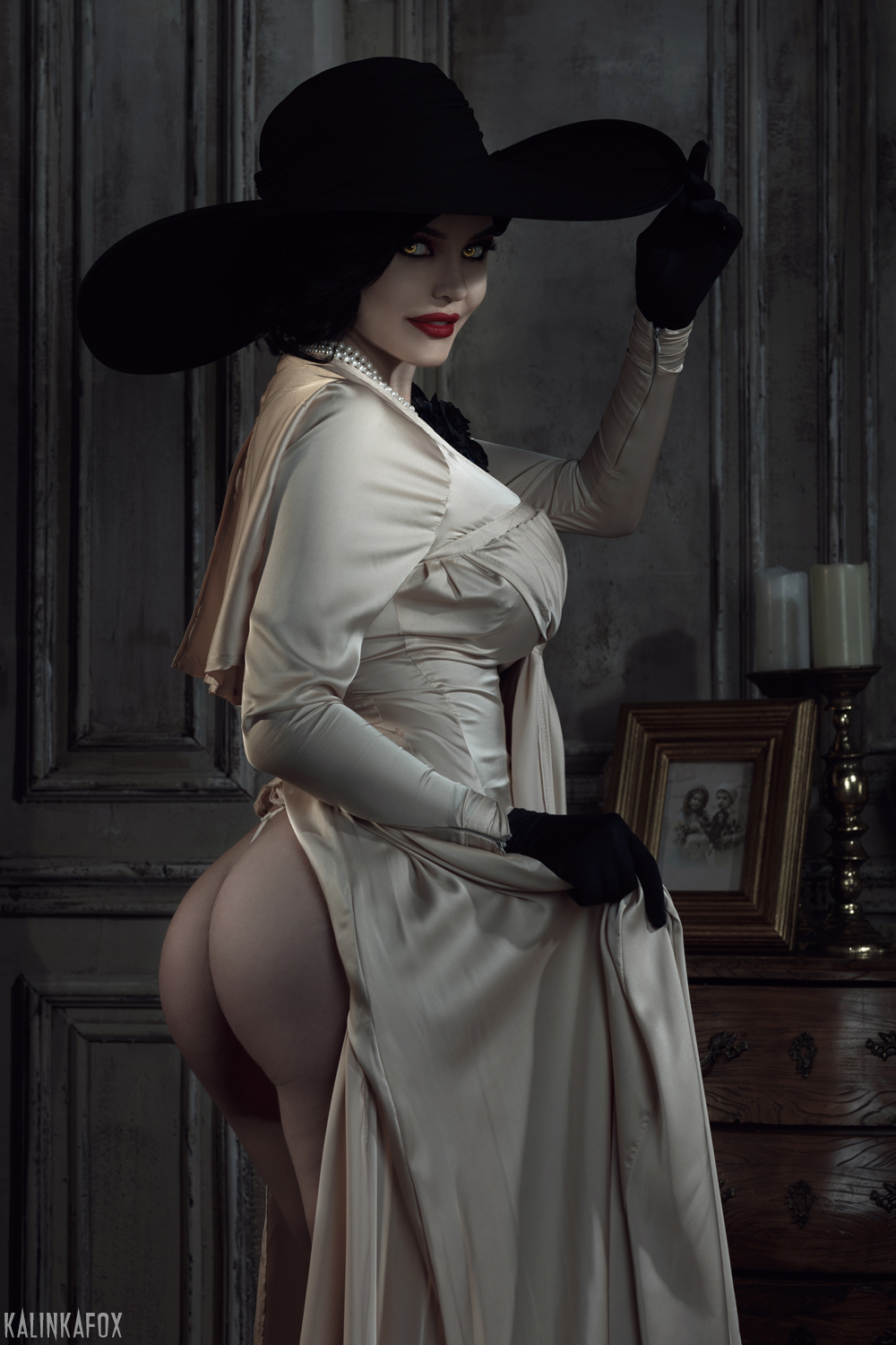 People 1000x1500 Kalinka Fox looking back looking at viewer gloves black gloves white dress black hat white clothing women indoors candles candle holder cosplay photography yellow eyes ass dress women hat Resident Evil 8: Village Resident Evil smiling video game girls model women with hats portrait display Lady Dimitrescu red lipstick
