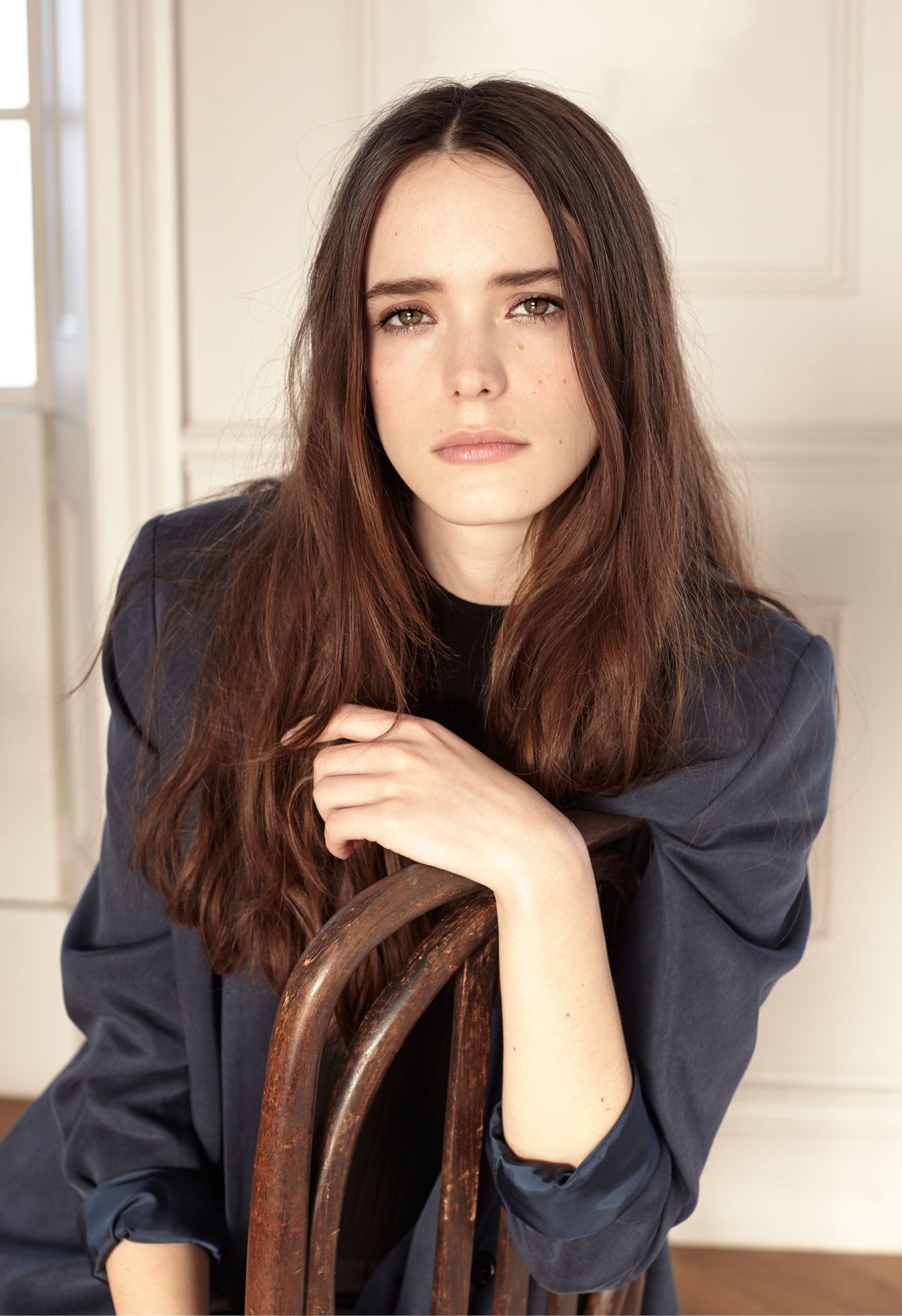 People 1440x2100 Stacy Martin women actress French French actress brunette long hair women indoors sitting pale white door sitting on chair looking at viewer