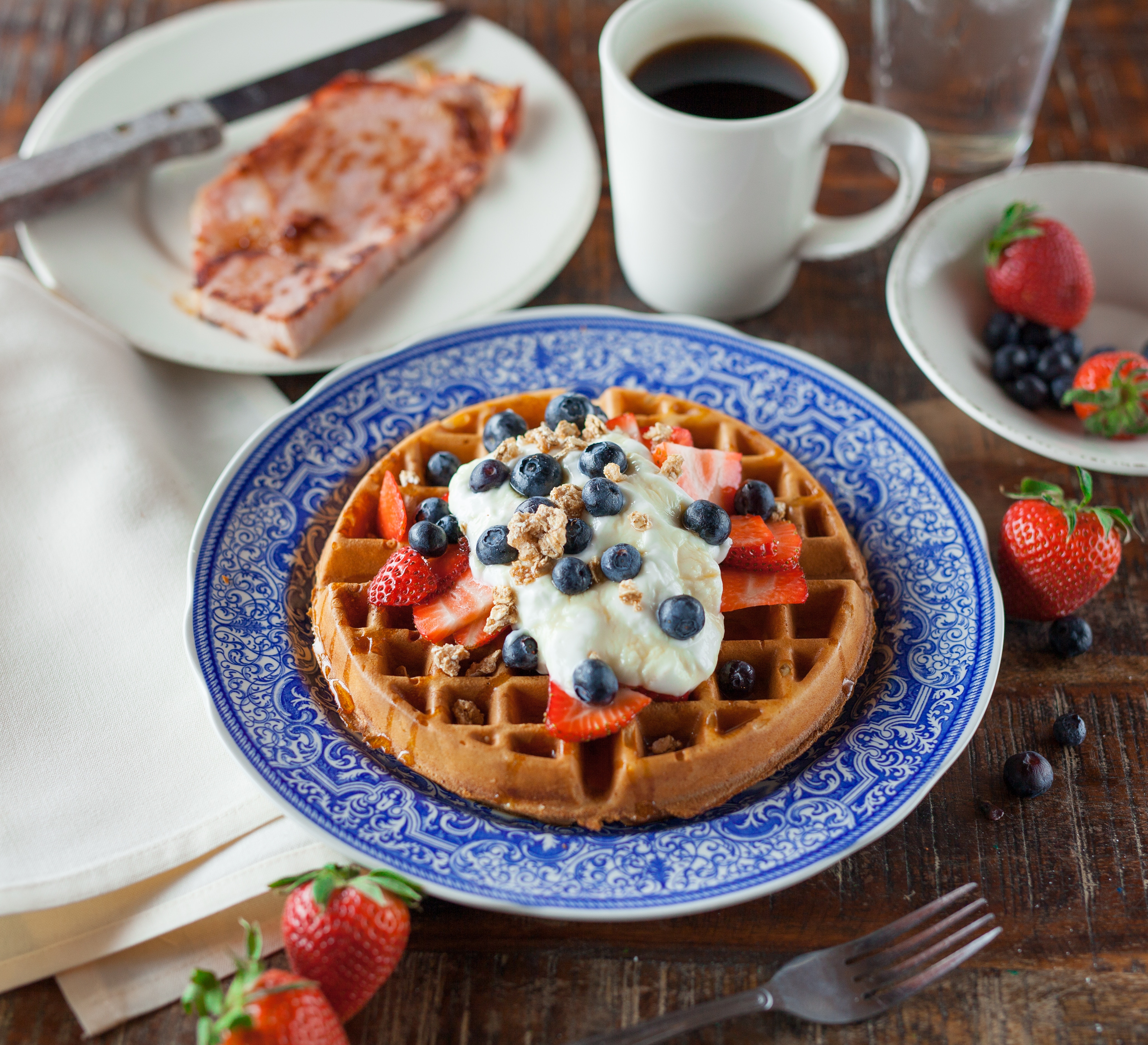 General 4113x3744 waffles coffee plates strawberries blueberries food table knife wooden surface closeup fork cup drink still life berries