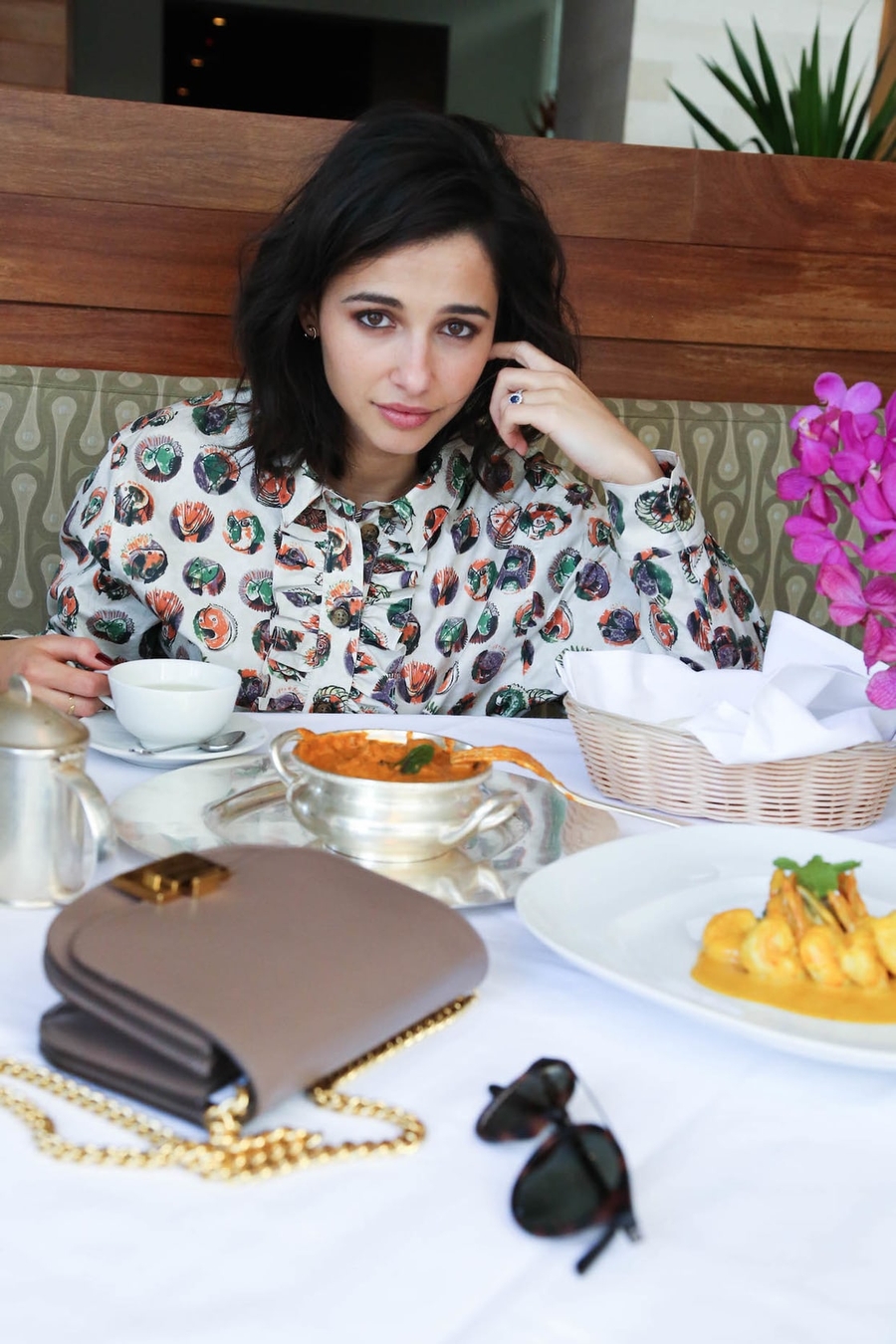 People 900x1350 Naomi Scott actress women portrait display sitting looking at viewer cup plates food purse closed mouth flowers earring spoon black hair table rings wood leaves