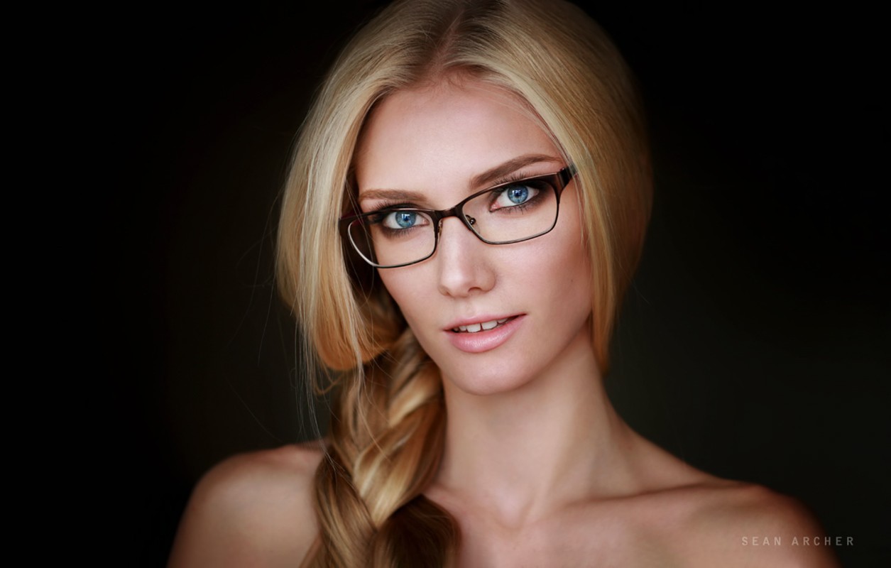 People 1255x800 women model face portrait women with glasses glasses simple background Sean Archer blue eyes bare shoulders blonde twintails looking at viewer closeup women indoors indoors parted lips dark background watermarked long hair studio