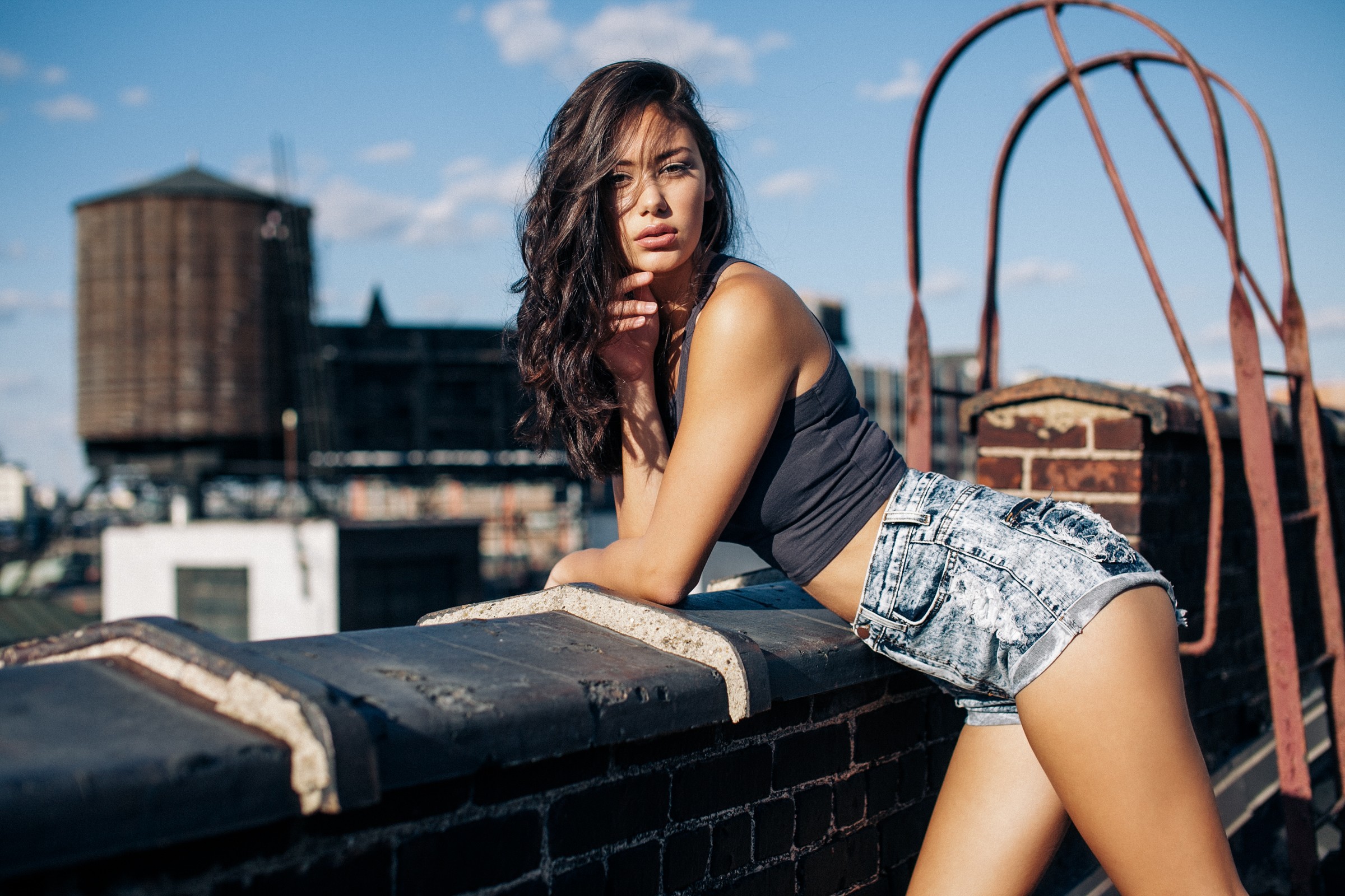 People 2400x1600 women brunette legs tank top T-shirt shorts jean shorts rooftops bare shoulders looking at viewer long hair women outdoors model urban hair in face bent over
