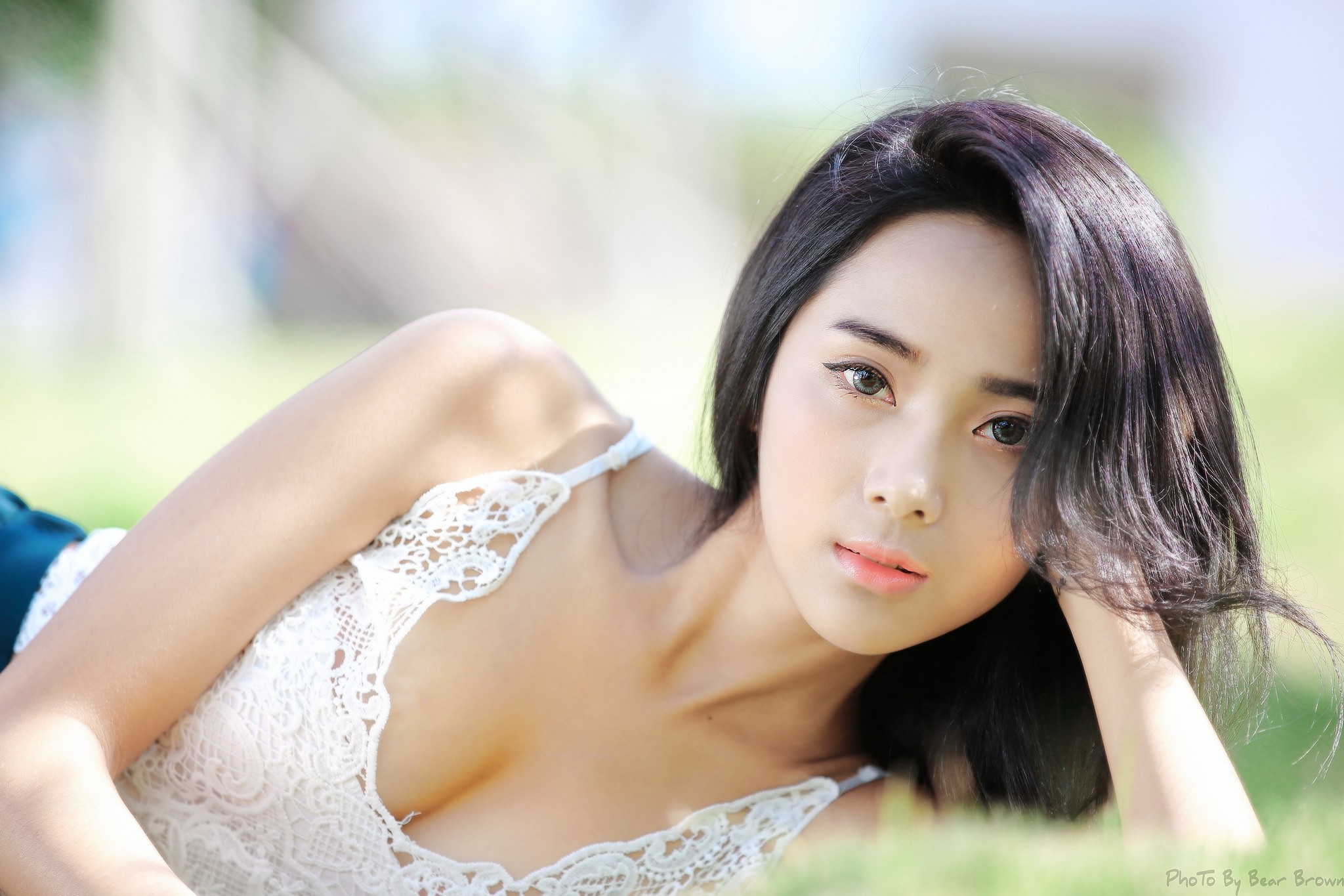 People 2048x1365 women brunette wavy hair lying down looking at viewer depth of field camisole cleavage gray eyes Asian Chinese women face closeup portrait dark hair women outdoors urban model