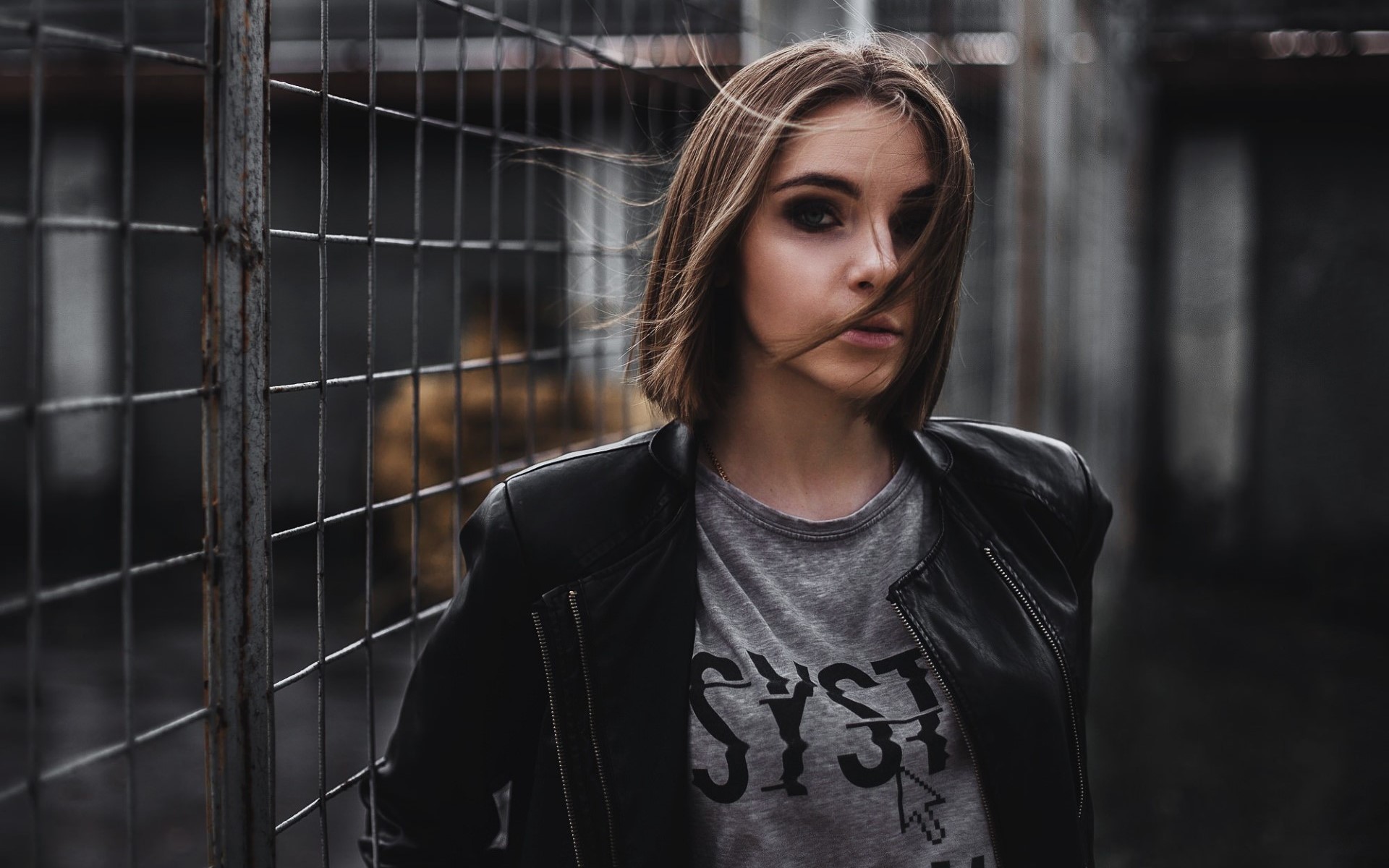 People 1920x1200 fence women urban model face T-shirt metal grid makeup hair in face brunette looking at viewer leather jacket