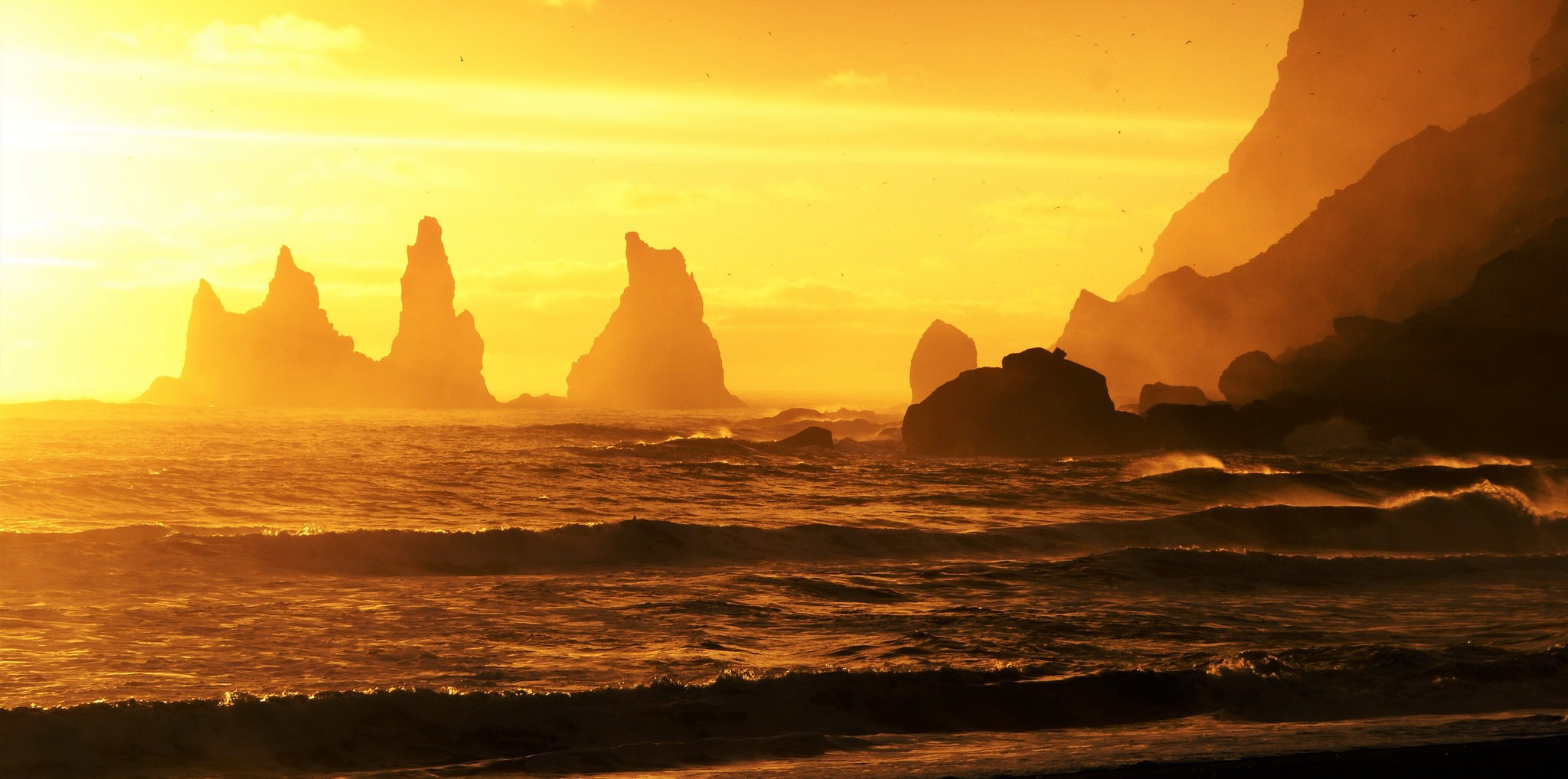 General 2048x1018 mountains sea waves sunset sunlight nature rocks Sun Iceland yellow sky water coast cliff silhouette
