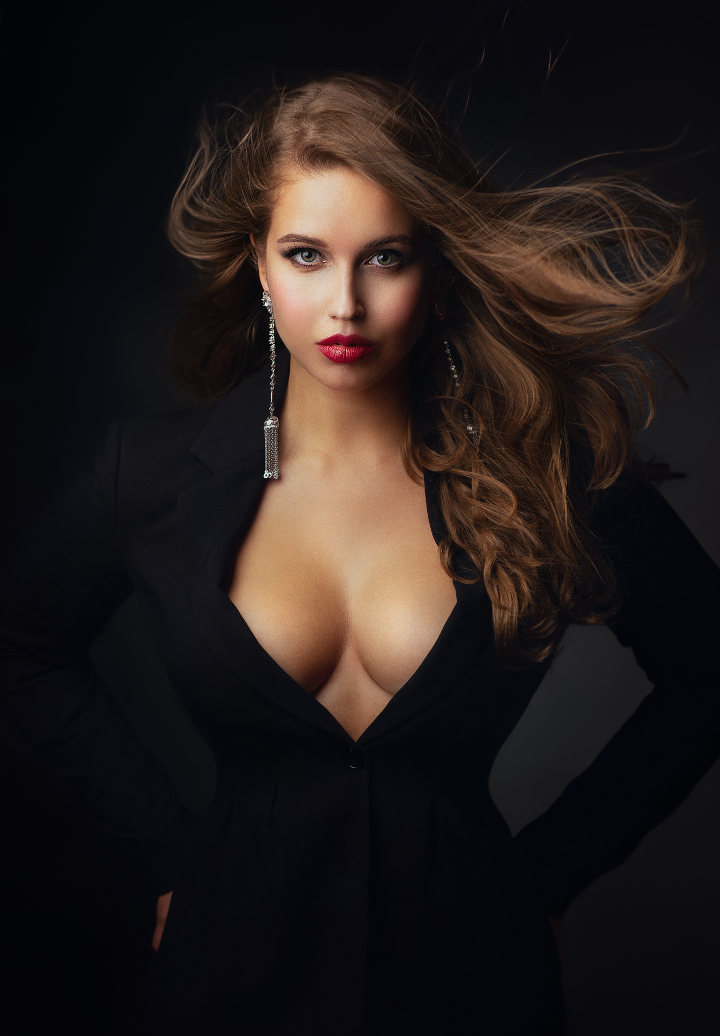 People 1424x2048 Zachar Rise women brunette long hair messy hair wind makeup looking at viewer eyeliner lipstick blue eyes jewelry earring suits black clothing cleavage simple background