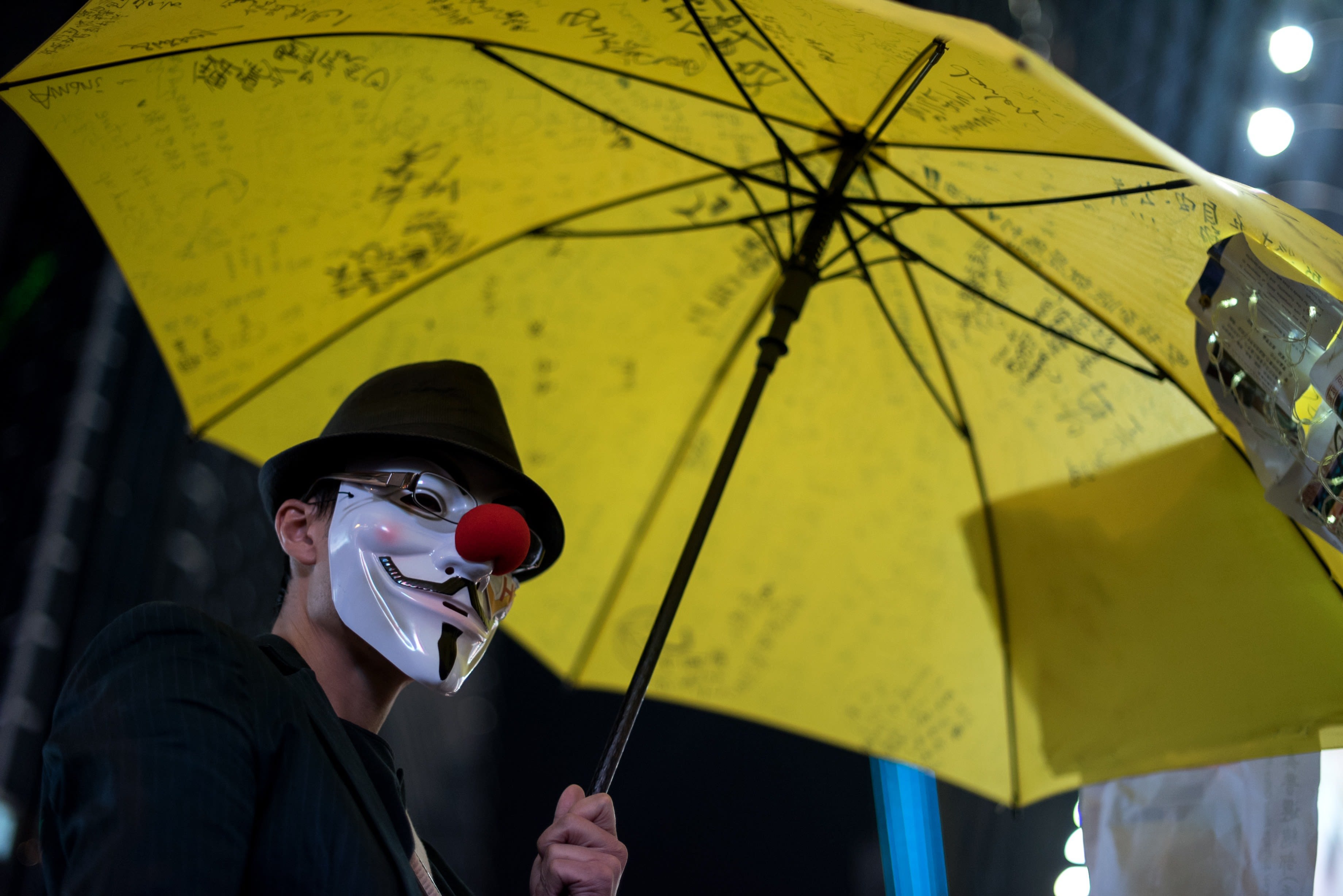People 3680x2456 umbrella Hong Kong Umbrella Movement yellow protestors men night mask hat red nose men outdoors lights