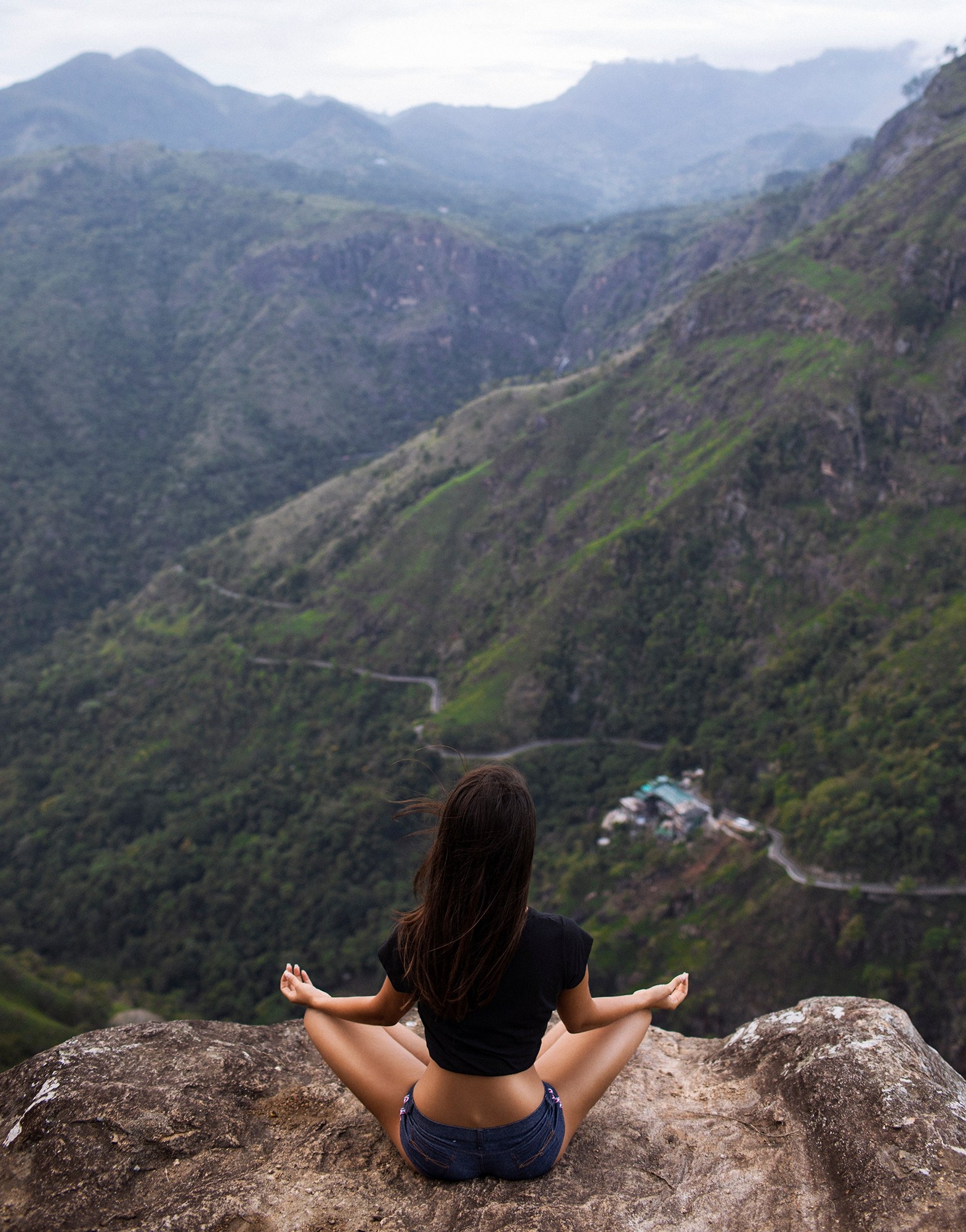 People 1569x2000 Aleksandr Mavrin Irina Dreyt women model legs crossed sitting rear view jean shorts depth of field heights yoga pose portrait display outdoors mountains landscape nature road on the ground