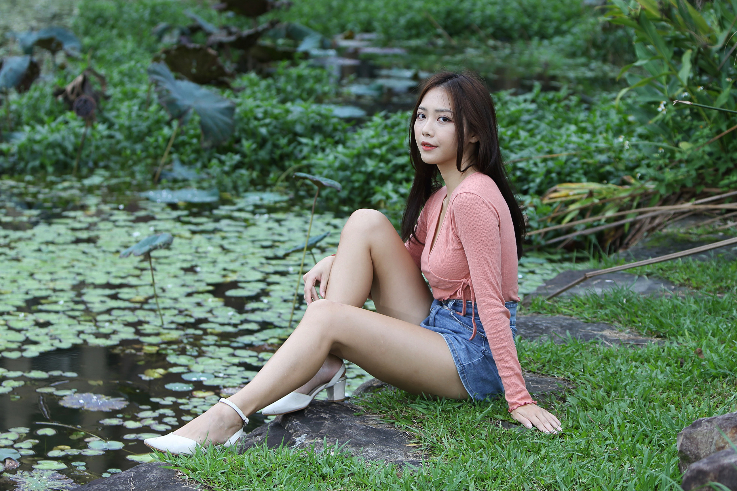 People 2560x1706 Asian model women long hair dark hair sitting jean shorts grass depth of field pond white shoes long sleeves shirt bushes high waisted shorts outdoors women outdoors white heels high heels white high heels black hair legs red lipstick looking at viewer
