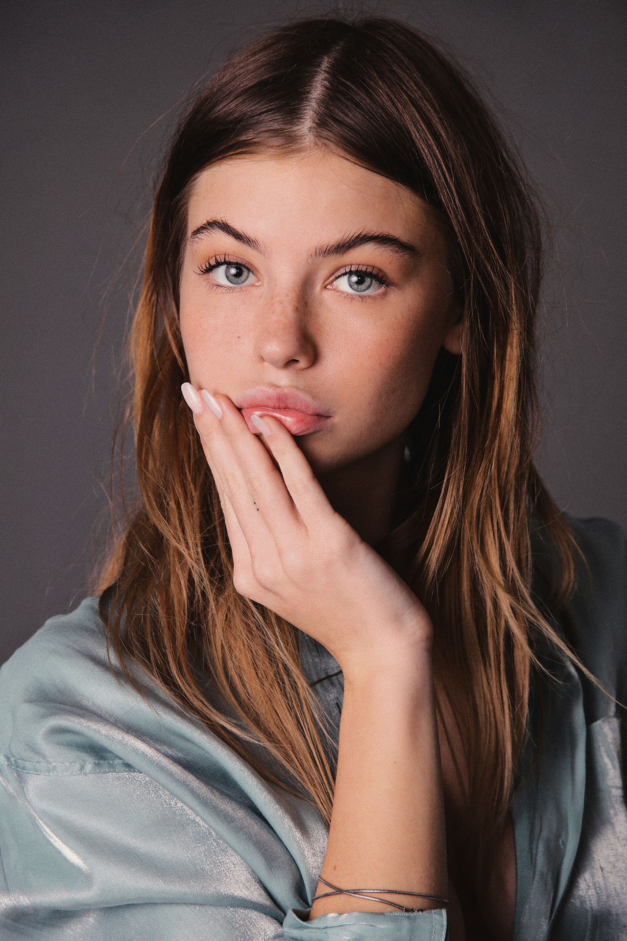 People 1280x1920 Kate Li model women Raffaele Marone simple background looking at viewer gray eyes finger on lips touching face gray background blue shirt face