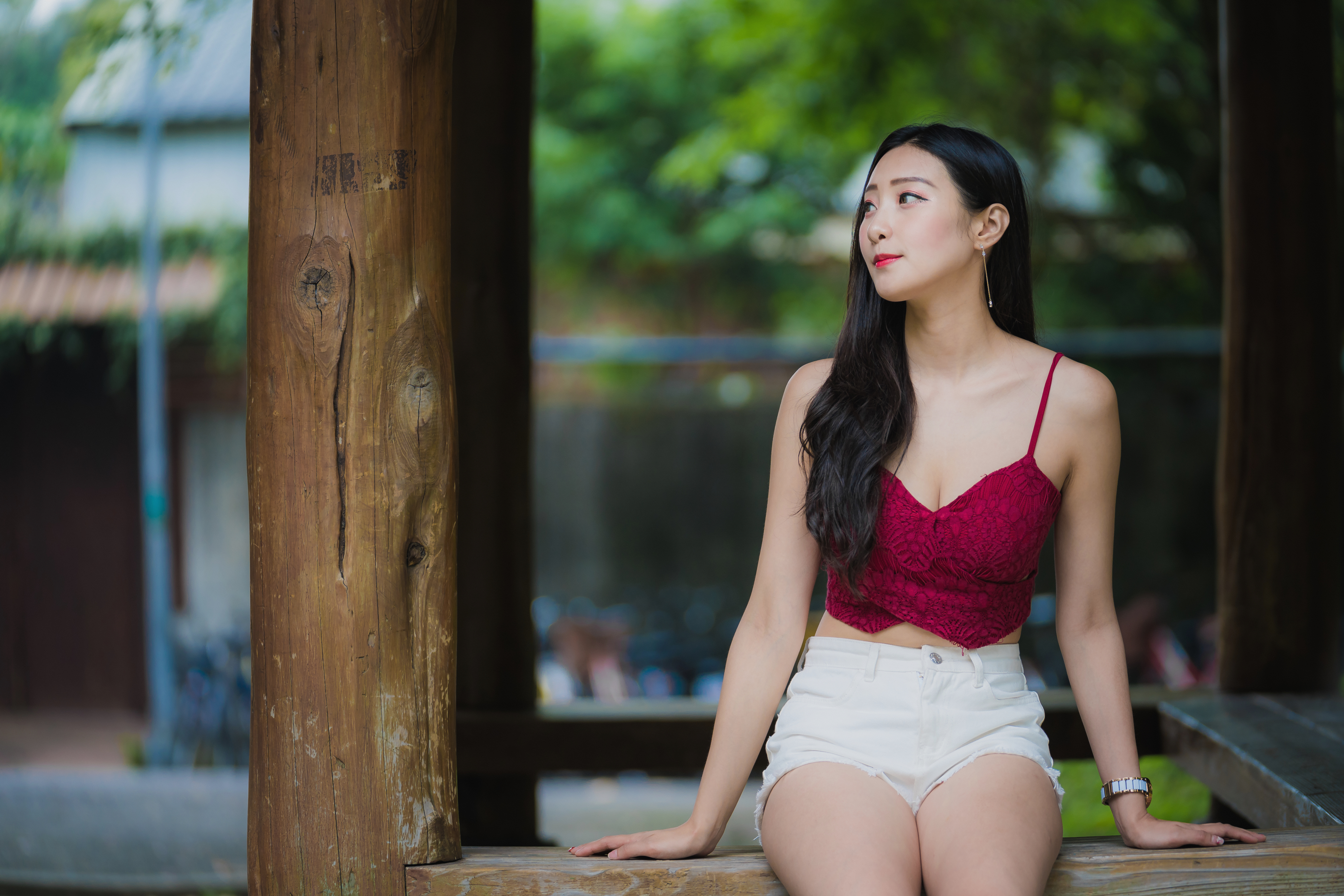People 4500x3002 Asian women model brunette long hair looking away smiling tank top red tops cleavage jean shorts short shorts thighs depth of field log portrait sitting frontal view outdoors women outdoors watch red lipstick earring