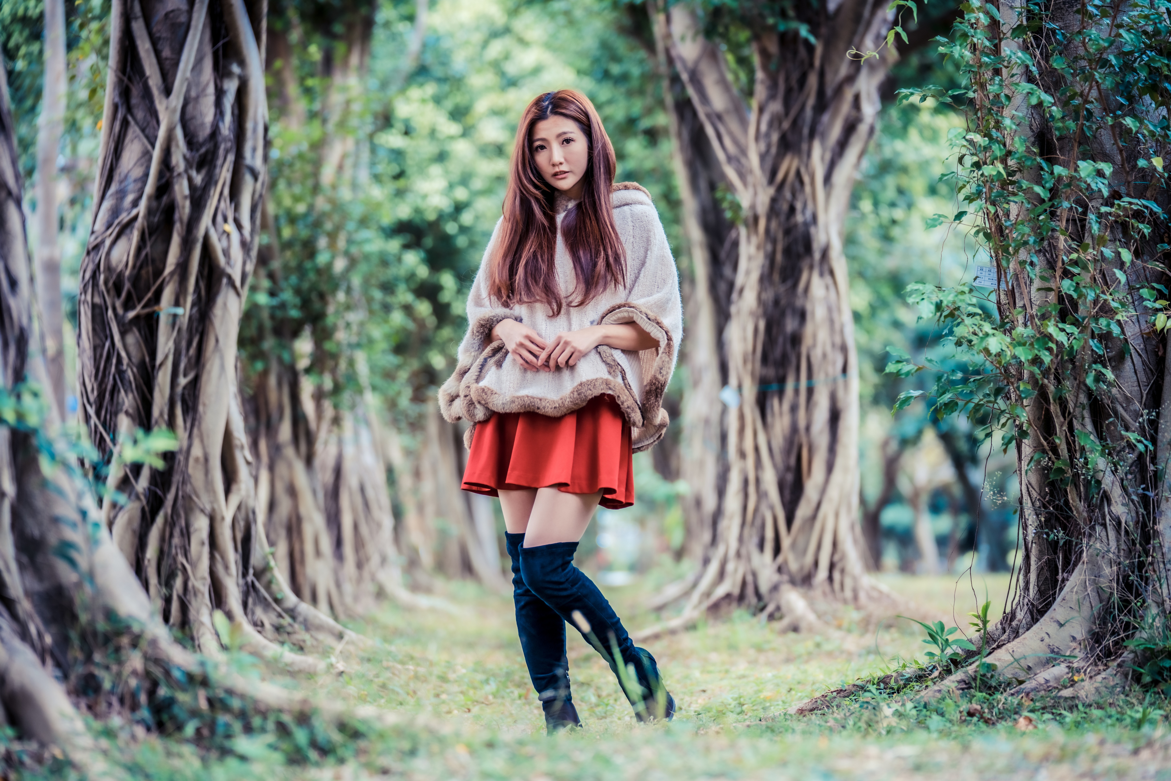People 4562x3043 Asian women model long hair brunette trees grass knee-high boots fur coats red skirt looking at viewer outdoors women outdoors depth of field standing frills leaves ground