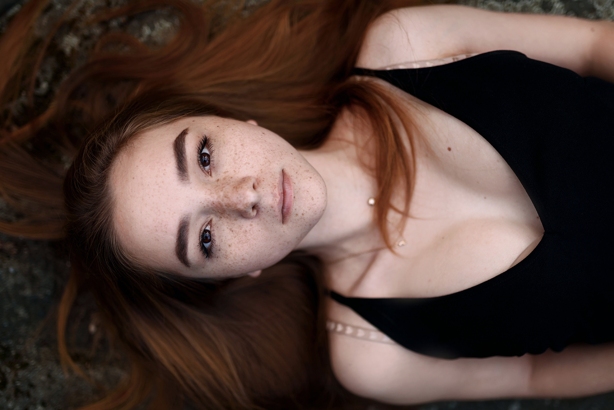 People 2403x1604 women model redhead long hair looking at viewer brown eyes portrait face freckles lying on back necklace cleavage top view bokeh outdoors women outdoors Juliana Naidenova black clothing closeup