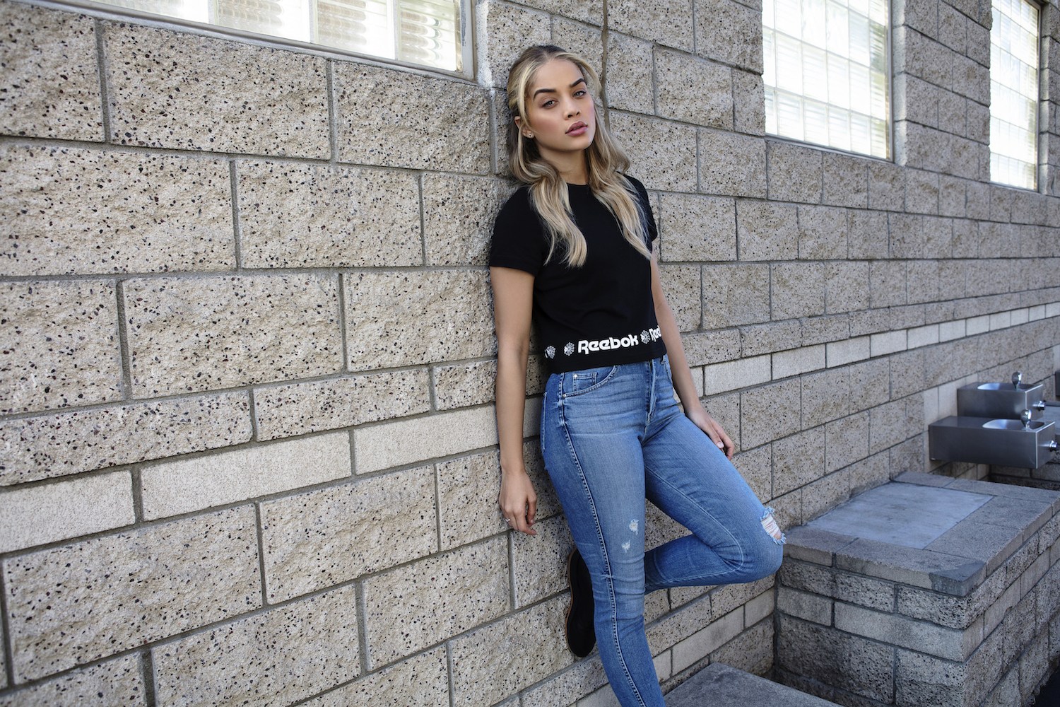 People 1500x1000 women model blonde long hair Jasmine Sanders jeans Reebok T-shirt bricks wall
